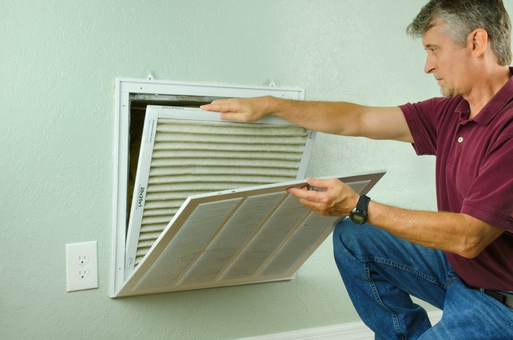 Man removing a dirty air filter