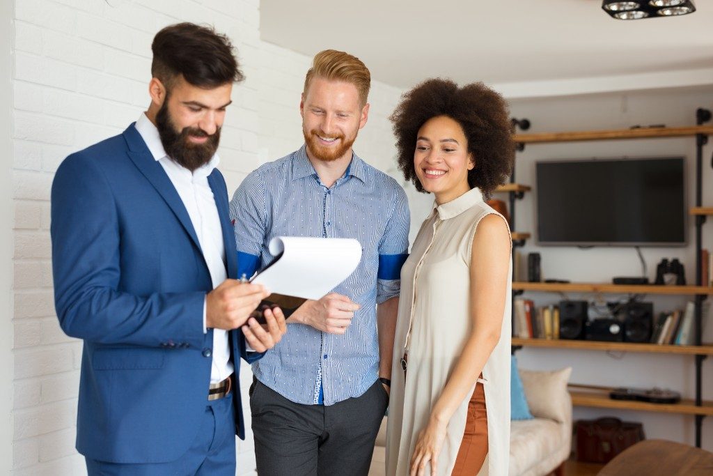 Couple with agent during a house visit