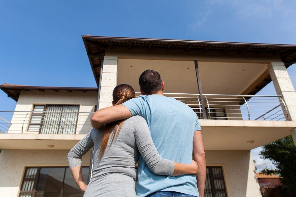 young couple looking at their new house