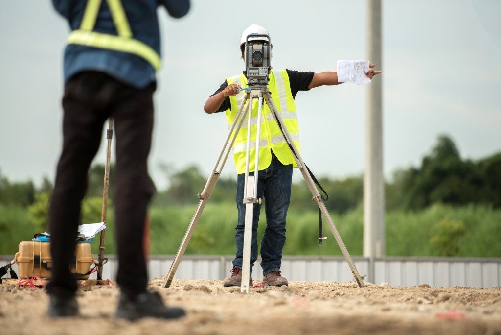 man surveying building site