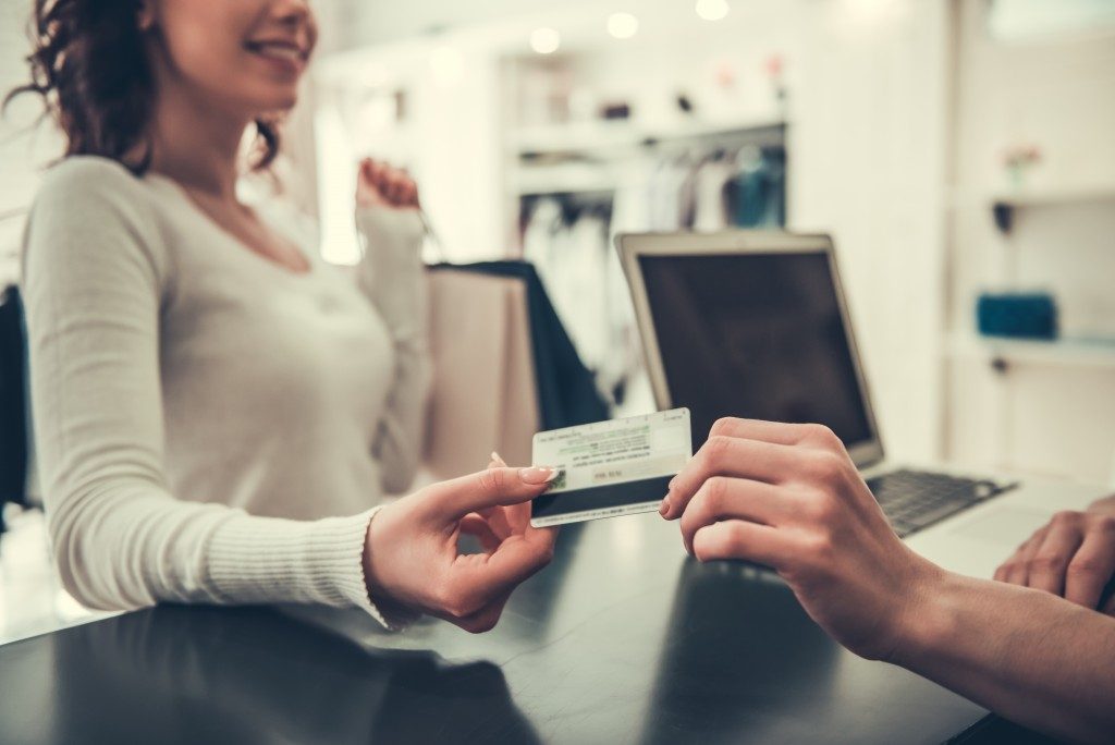 woman paying using her credit card