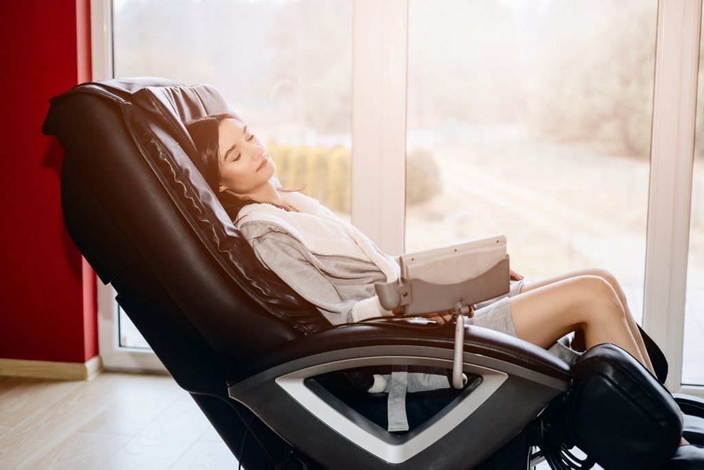 Woman sitting on a massage chair