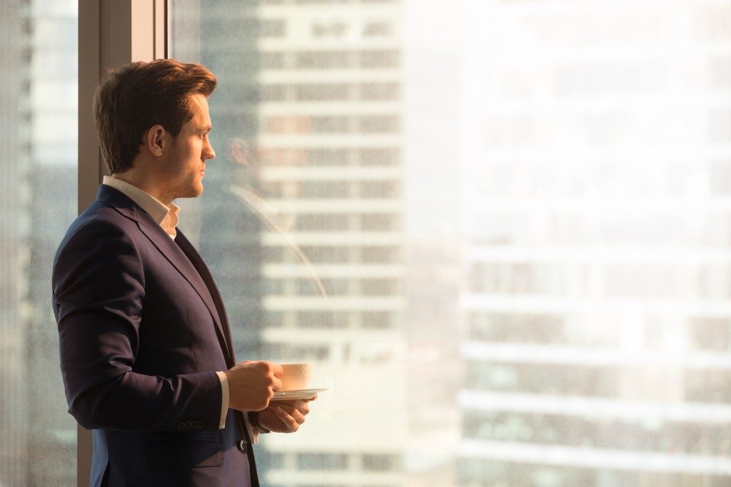 businessman looking at buildings from window