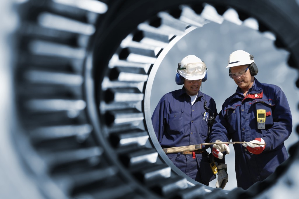 workers checking machines in the site