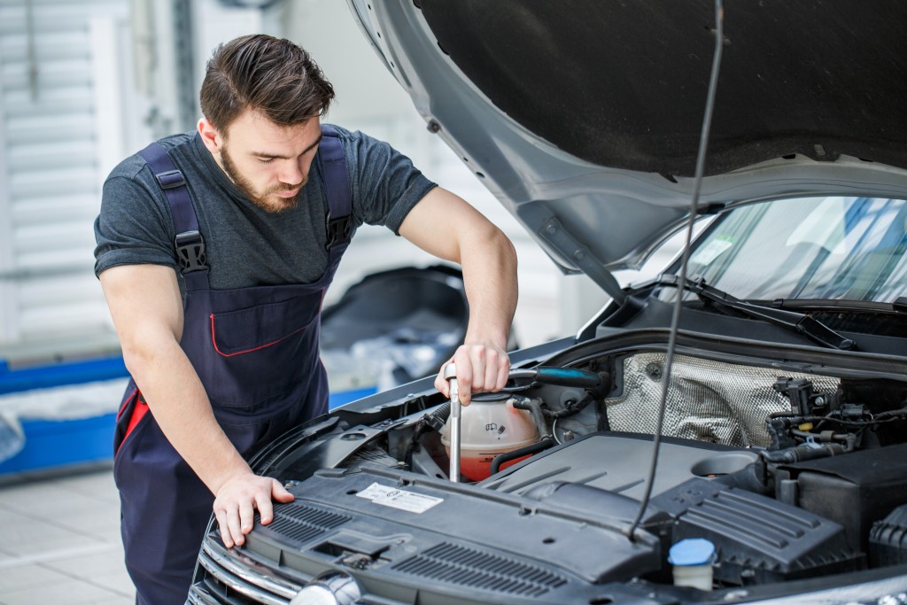 man repairing a car