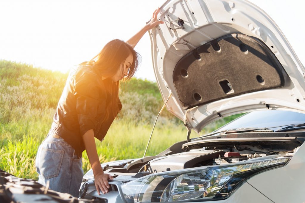 girl checking her car