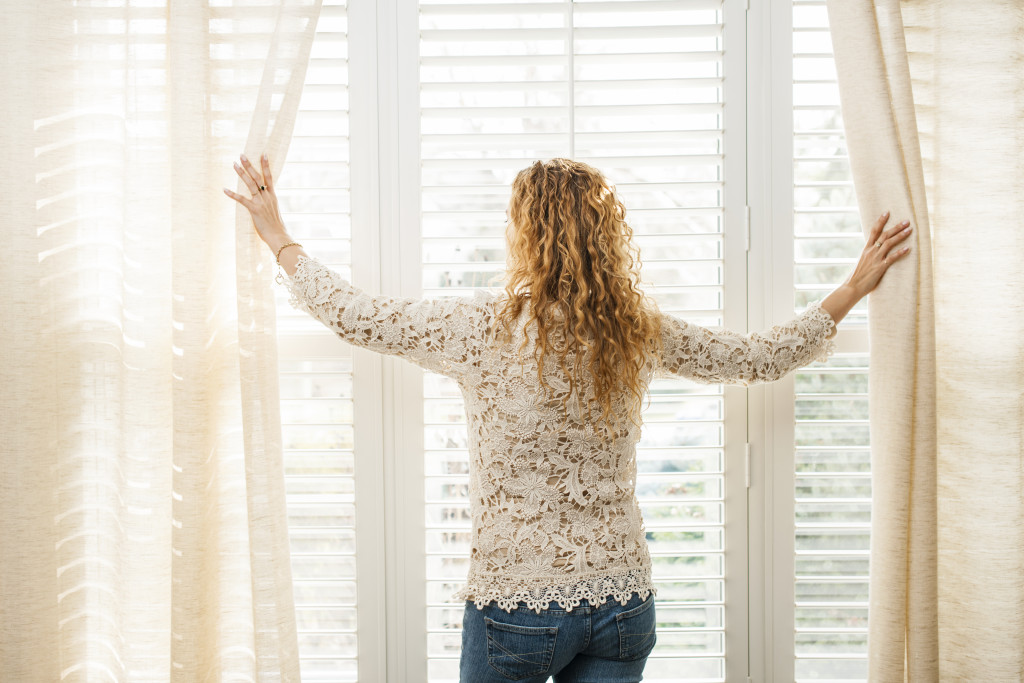 woman standing by the window