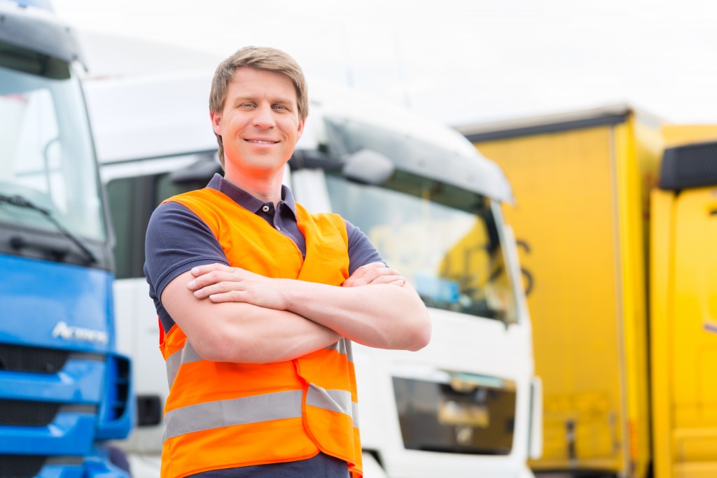 truck driver infront of trucks