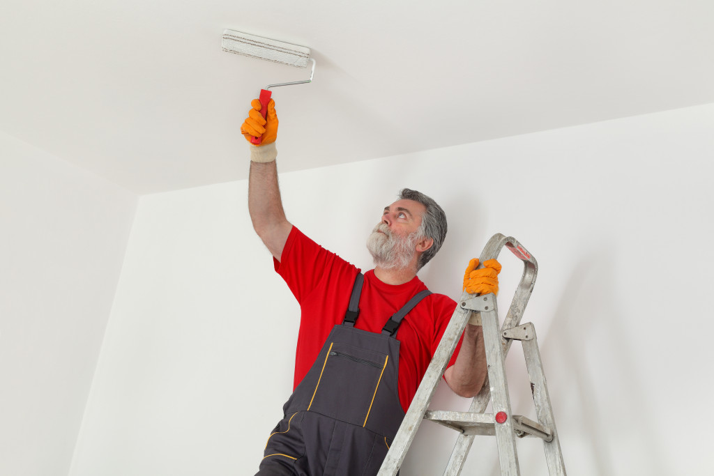 man painting wall