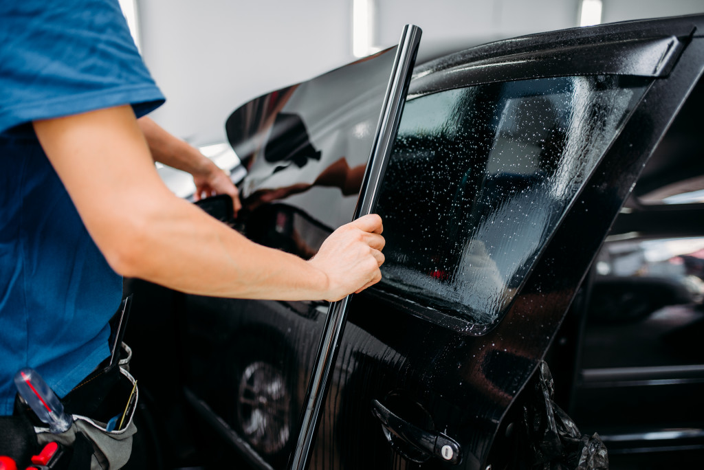 man customizing a car