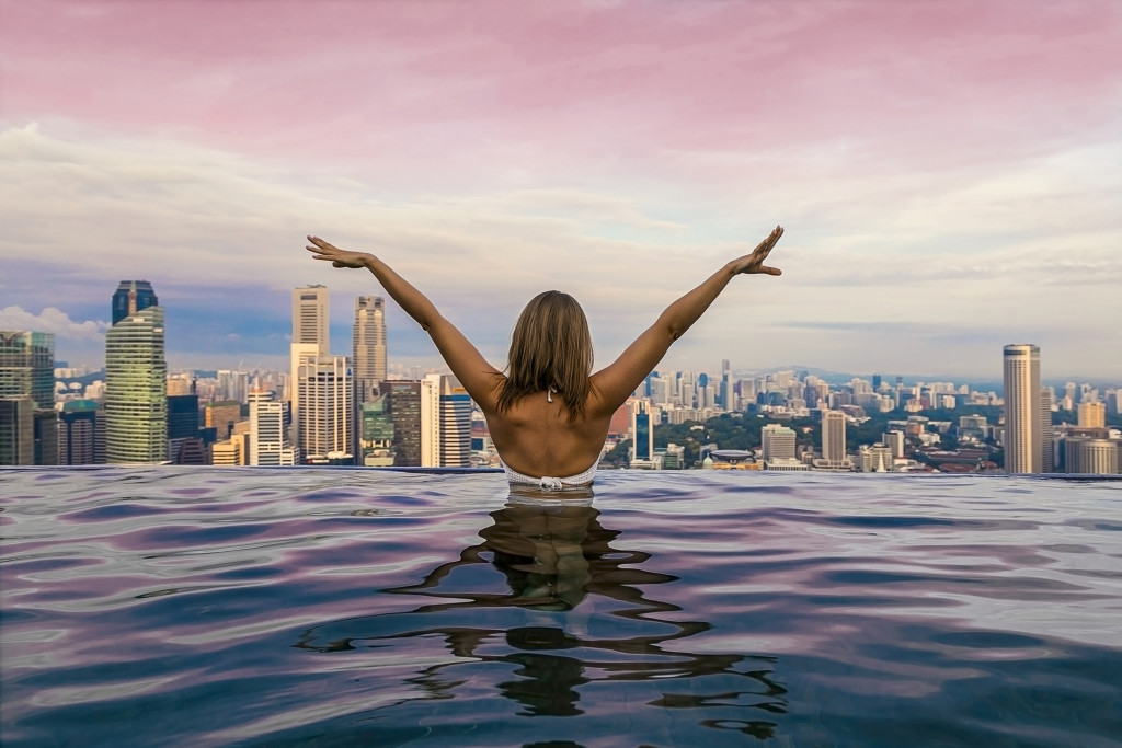 woman in a rooftop pool of the hotel