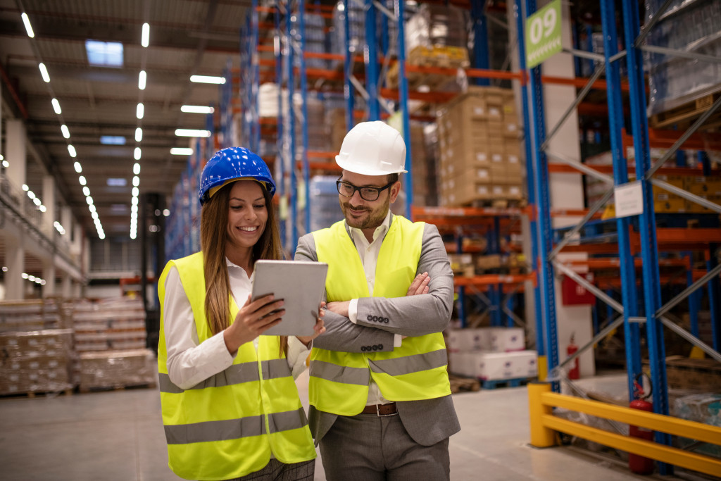 man and woman wearing a protective gear in a warehouse