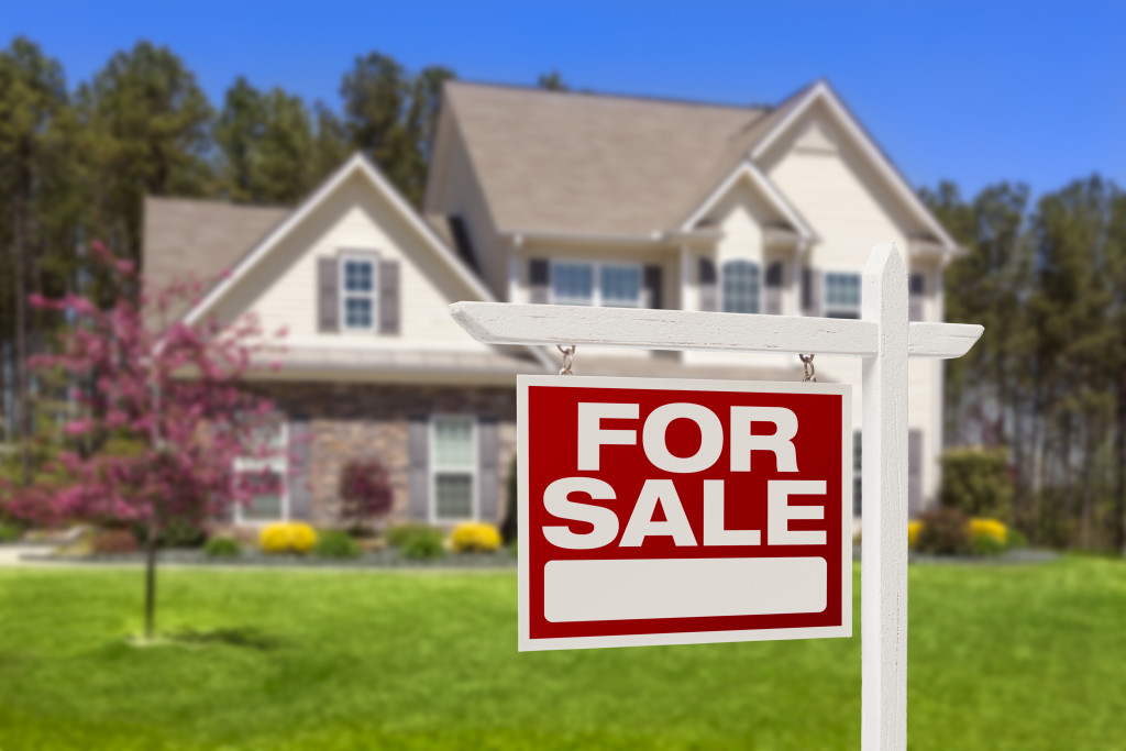 white house with brown roof for sale