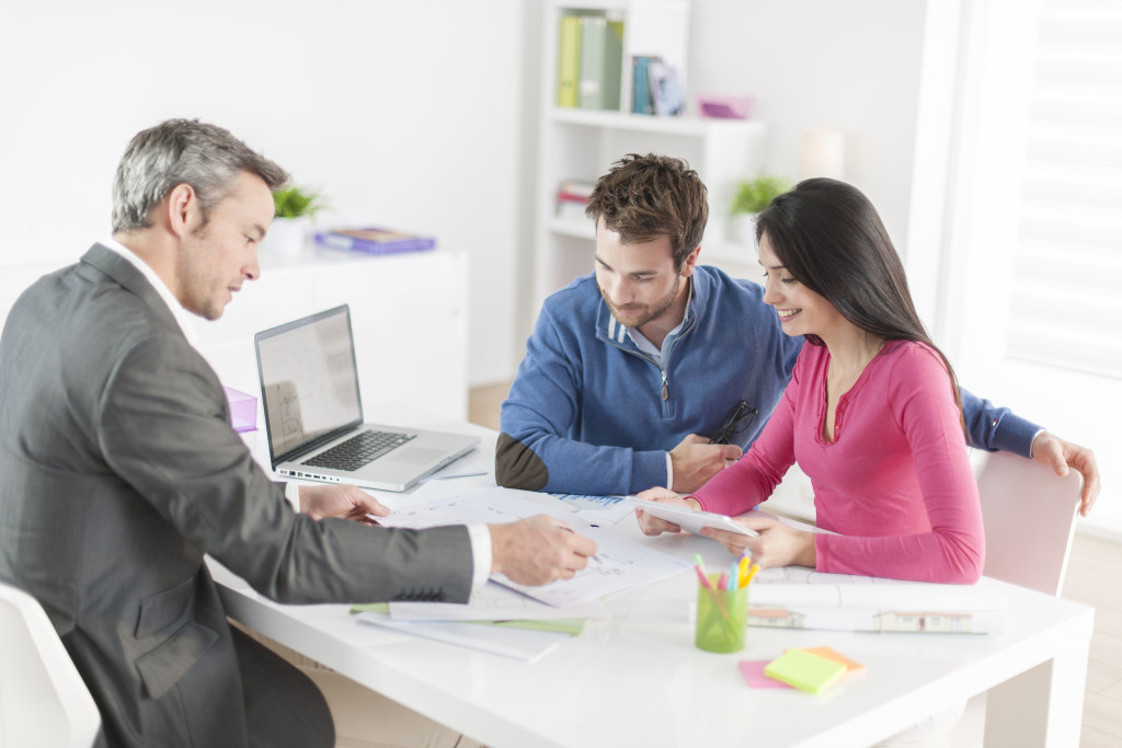 Couple meeting with their real estate agent in his office