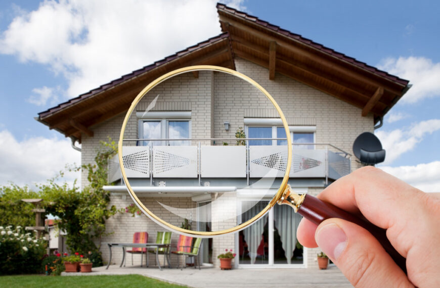 person with magnifying glass on luxury suburban house